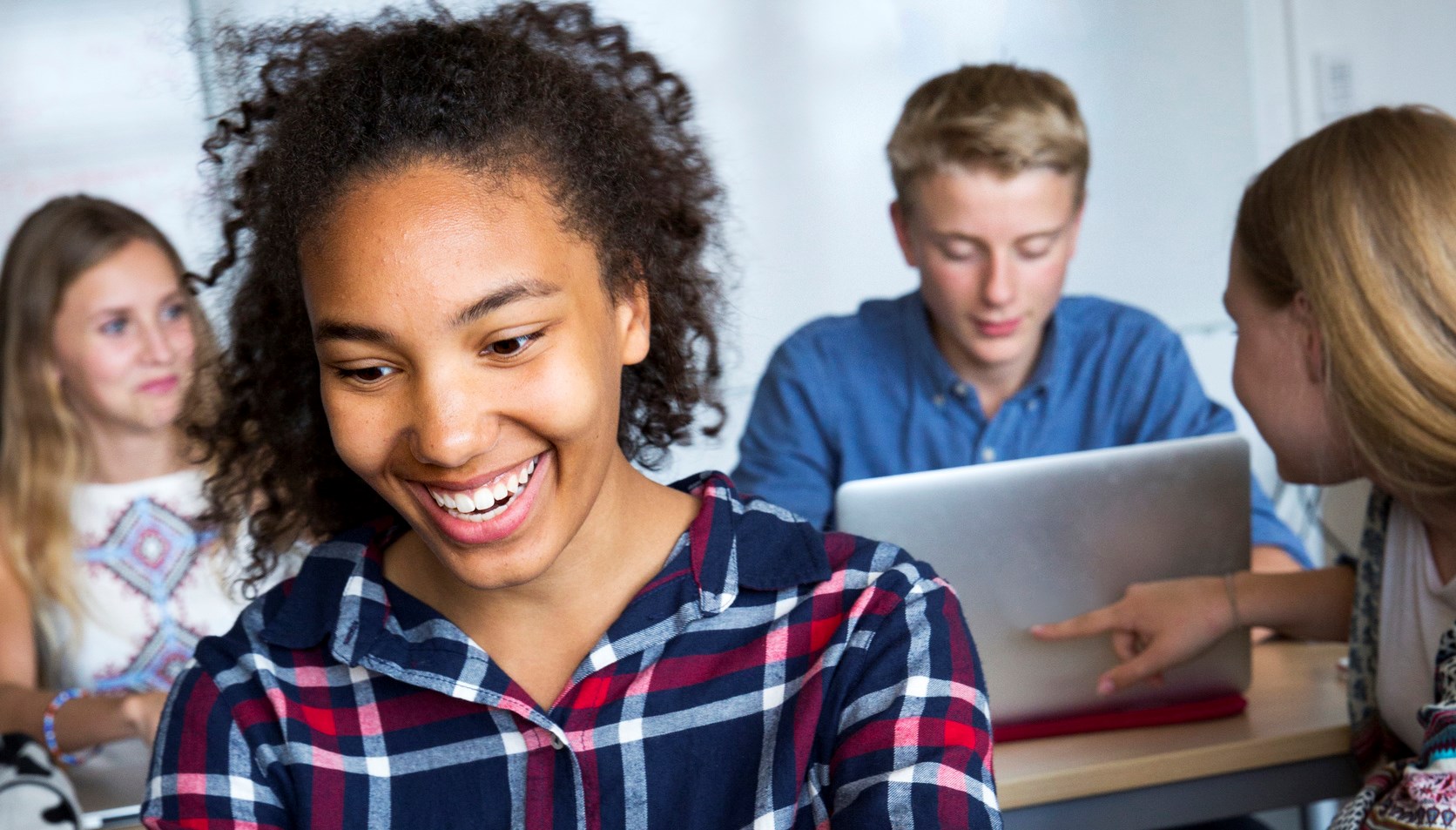 Teenagers with laptop in classroom